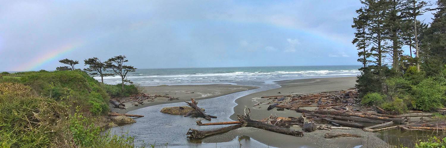 A rainbow stretches over Kalaloch Creek near Kalaloch Lodge in Olympic National Park