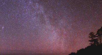 Starry night sky with the Milky Way over a silhouetted landscape at Olympic Peninsula.
