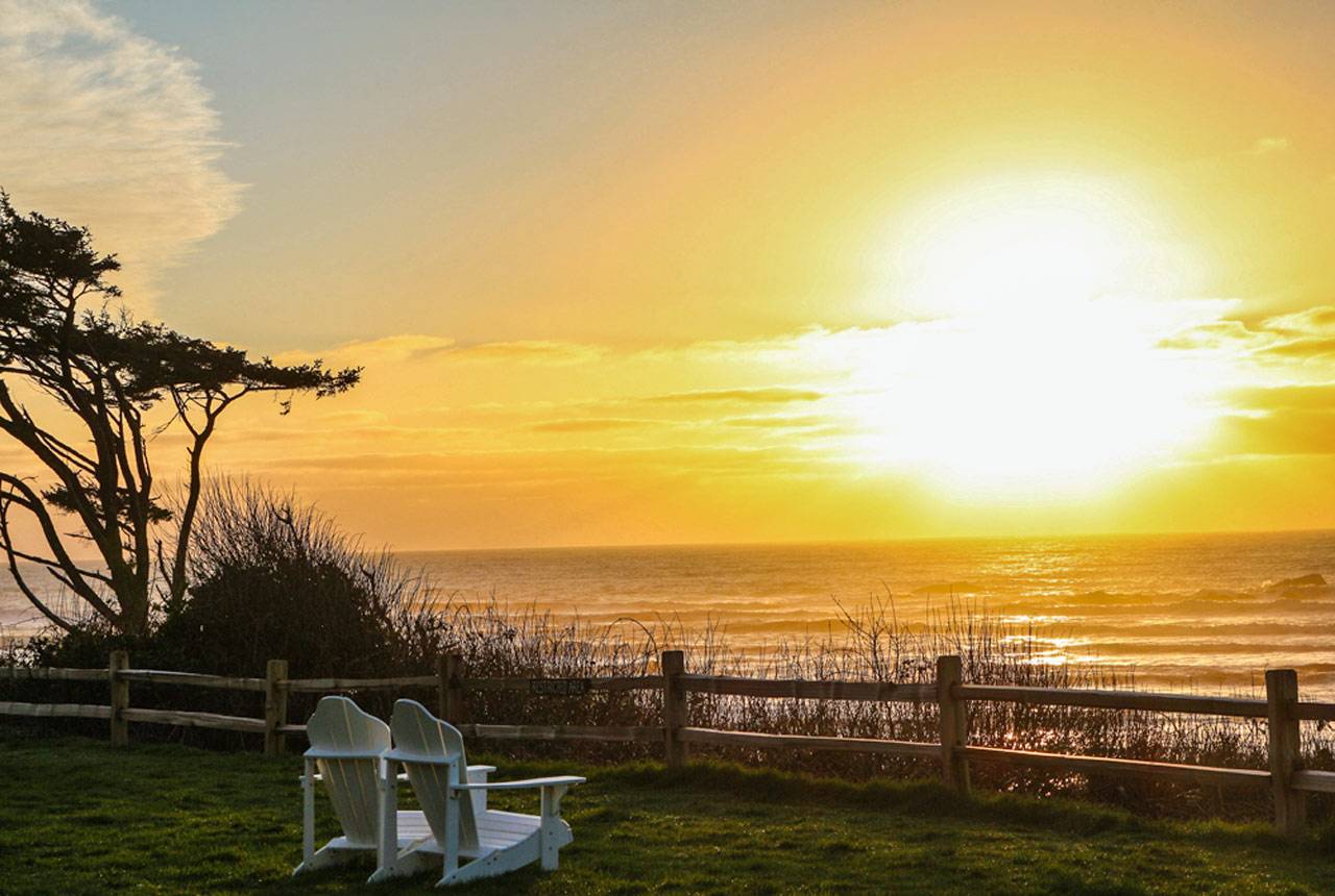 Adirondack chairs looking out at the sunset on Kalaloch Lodge bluff