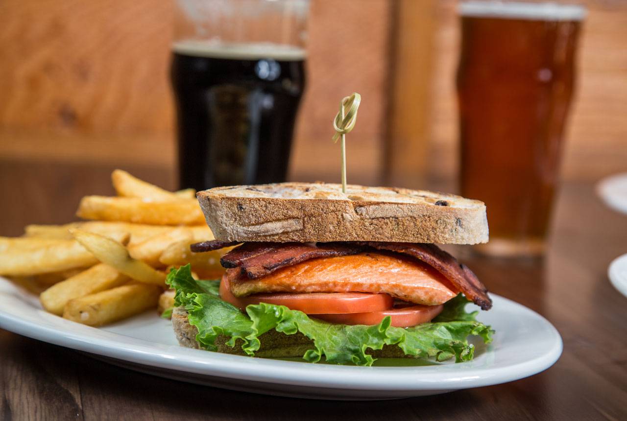 Savory salmon sandwiches at Creekside Restaurant at Kalaloch Lodge highlights meaningful partnerships with local food vendors.