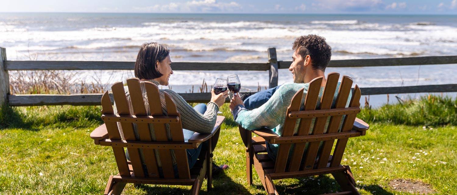 Two Kalaloch Lodge guests enjoying a glass of wine with a view of the ocean