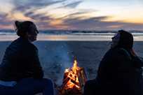 Two Kalaloch visitors enjoying a bonfire on the beach
